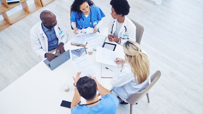 Above, healthcare and meeting by doctors on laptop for research, planning and innovation at hospital