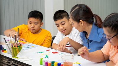 Asian disability boy learning color Painting in classroom with Autism girl in special school with female teacher