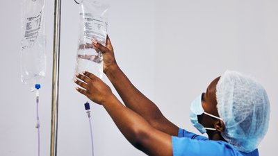 Black female nurse with iv drip medicine