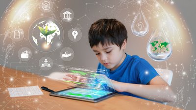 Boy using a tablet with images floating around him