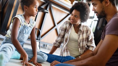 Child with Family at Home Talking and Smiling