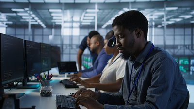 Focus on server hub employee developing disaster recovery plans ensuring minimal downtime