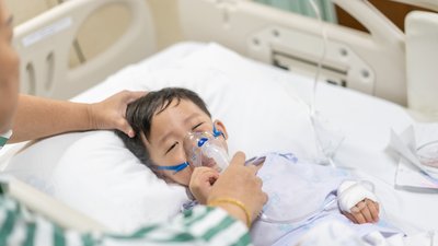 Grandmother take care a kid who is sick flu, He has difficulty breathing