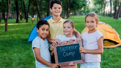 Happy Multicultural Kids Holding Chalkboard