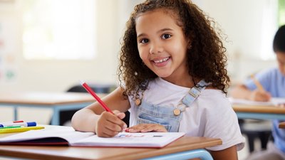 Happy student coloring for creative art in notebook