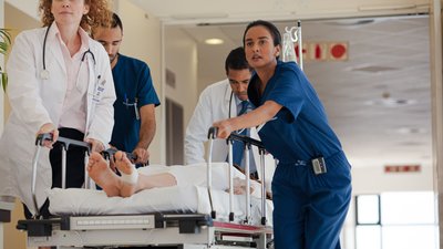 Hospital staff rushing patient to hospital room