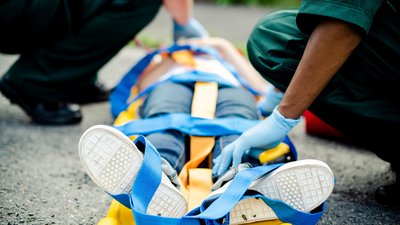 Paramedic team rescuing a young critical patient