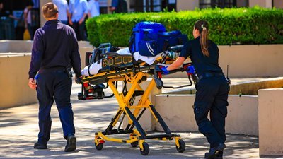 Paramedics pushing a gurny loaded with life saving equipment