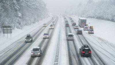 Snow covered highway in austria with cars out of focus