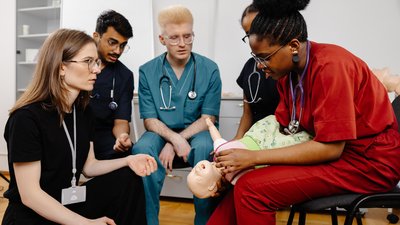 Team Inspecting Baby