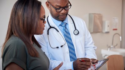 Two healthcare providers looking at document