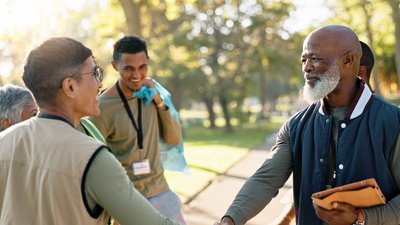 Two men shaking hands before starting a community project