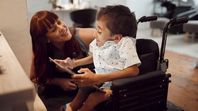 Woman and child with CP using a tablet