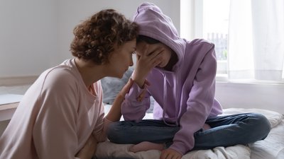 Worried parent young mom comforting depressed crying teen daughter bonding at home