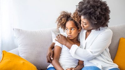 Worried young mother comforting child