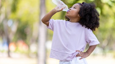 child drinking water on a hot day