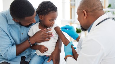 medical vaccine of a child with father and kid doctor or pediatrician